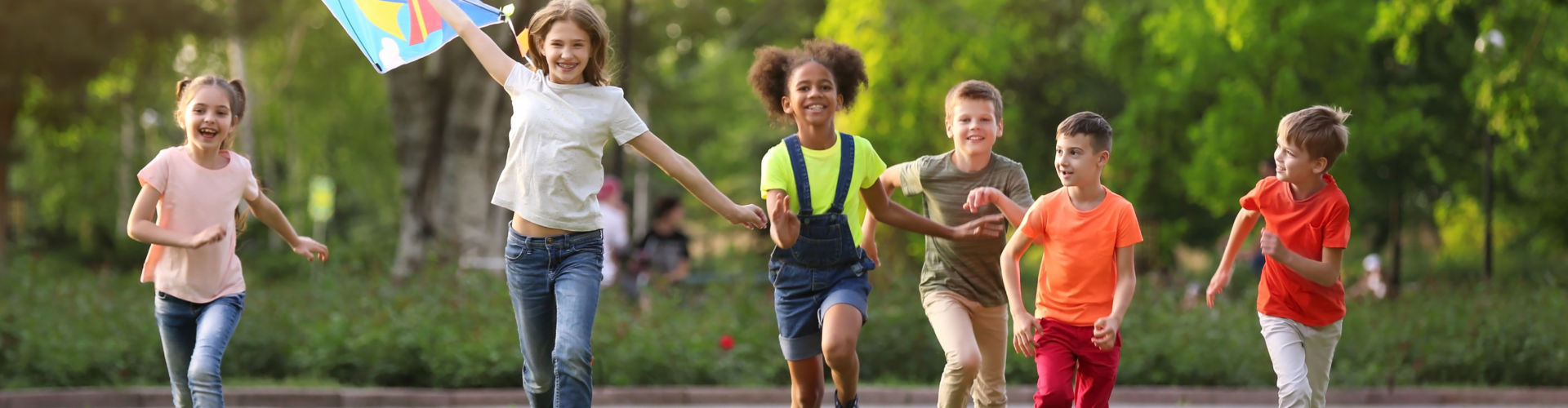 Cute little children playing with kite outdoors on sunny day